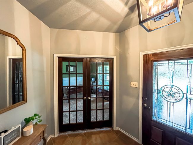 Entryway with dark tile patterned floors and french doors | Image 5