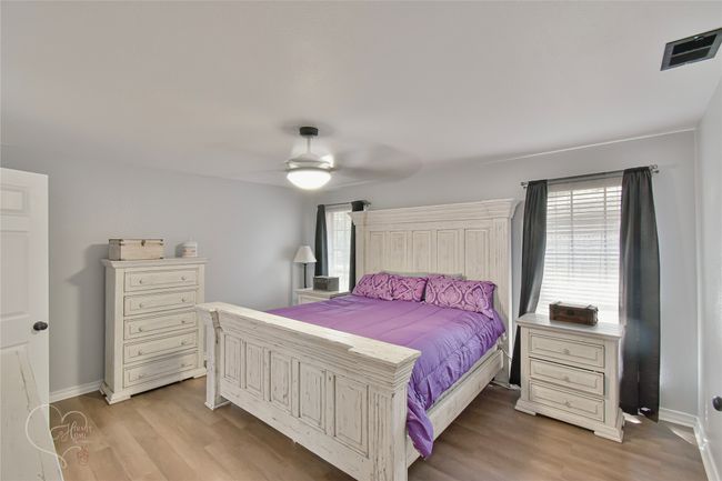 Bedroom featuring light wood finished floors and ceiling fan | Image 23