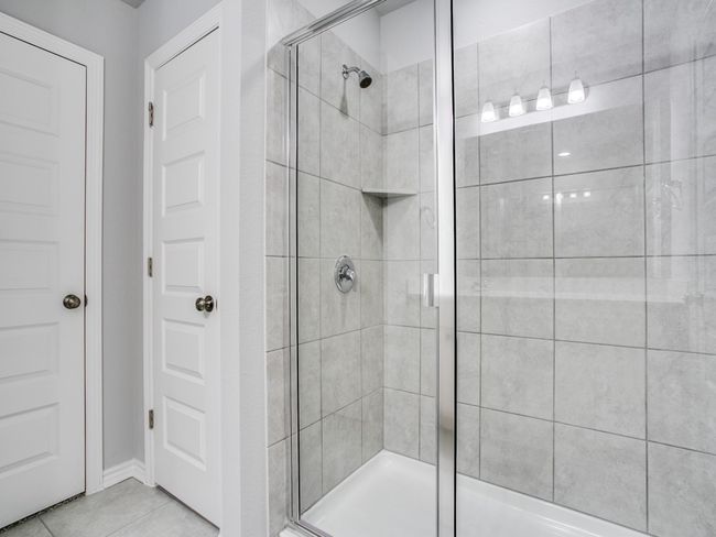 Full bathroom featuring a shower stall and tile patterned flooring | Image 16