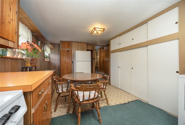 2nd Dining space featuring wooden walls and light carpet | Image 25