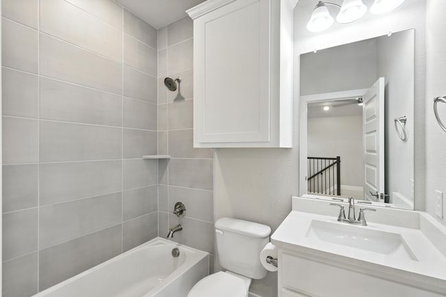 Bathroom in upstairs gameroom with shower / washtub combination, vanity, and a ceiling fan | Image 11