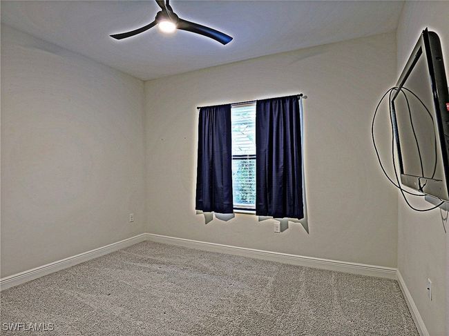 Spare room featuring carpet flooring, a ceiling fan, and baseboards | Image 21