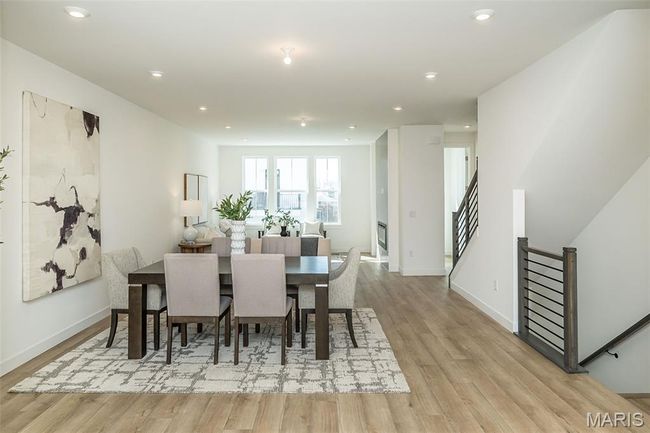 Dining room featuring light wood finished floors, recessed lighting, and stairs | Image 11