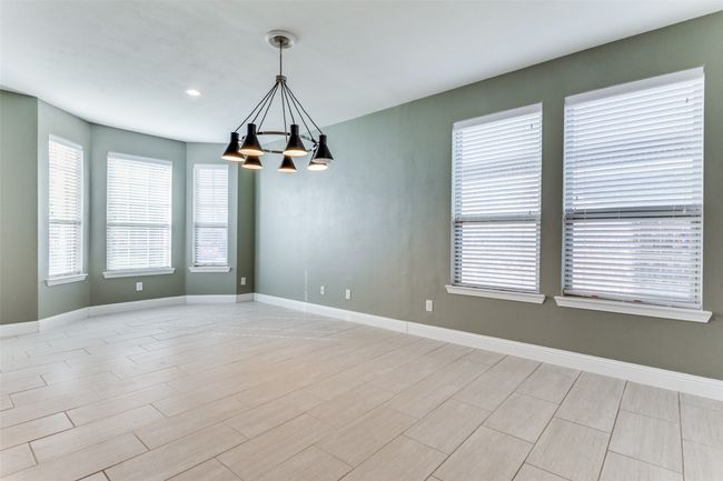 Spare room with a notable chandelier | Image 6