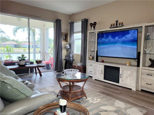 Living room with wood finished floors and a water view | Image 4