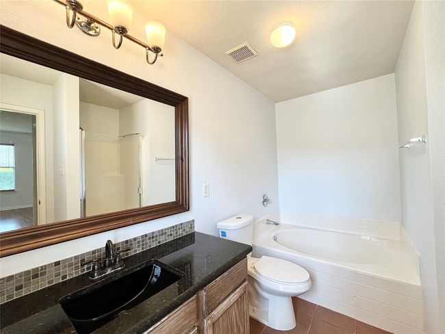 Full bathroom featuring a bath, vanity, and tile patterned flooring | Image 14