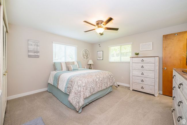 Bedroom featuring baseboards, ceiling fan, and light carpet | Image 32