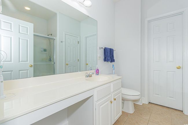 Bathroom featuring tile patterned flooring, vanity, toilet, and walk in shower | Image 18