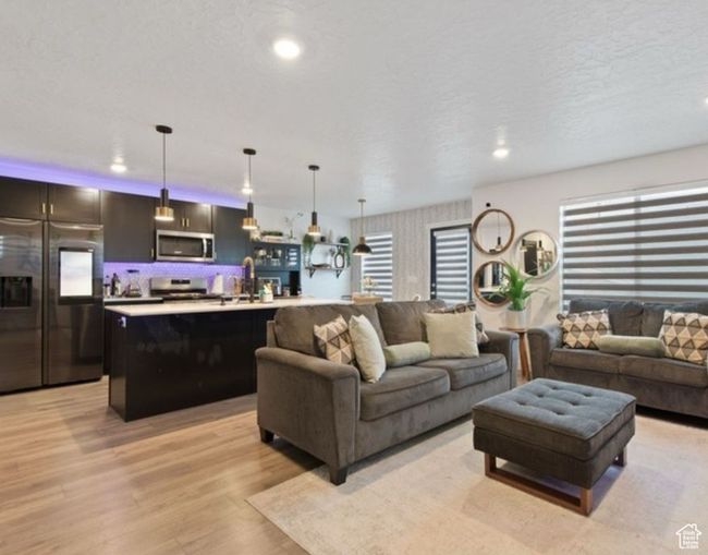Living area with light wood-style floors and recessed lighting | Image 4