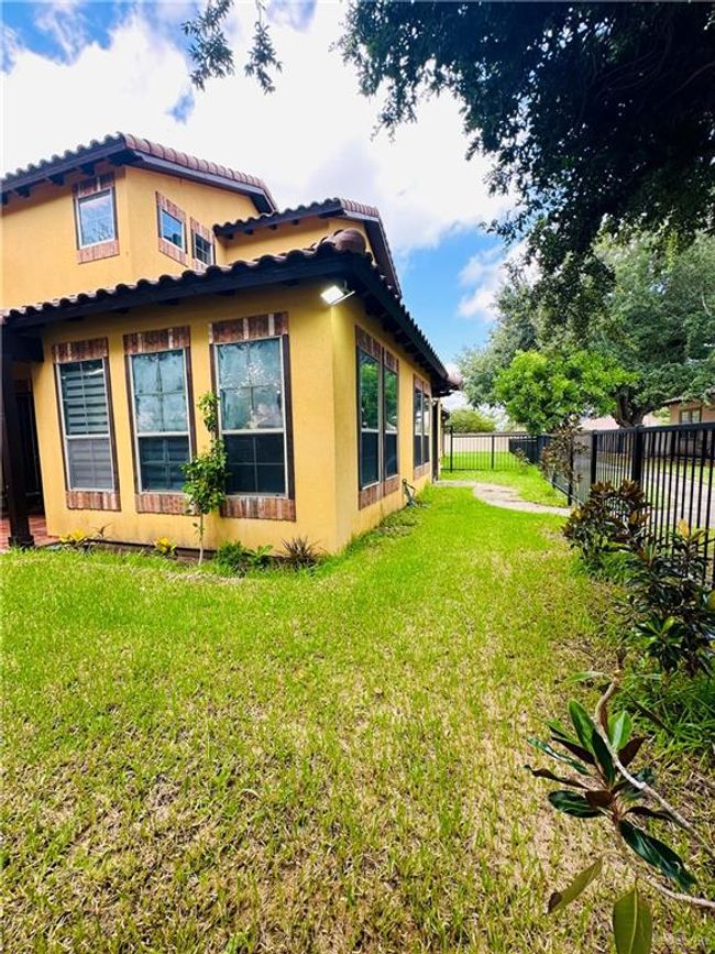 View of side of home with stucco siding and a tile roof | Image 27