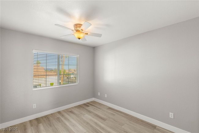 Unfurnished room with baseboards, a ceiling fan, and light wood-type flooring | Image 19