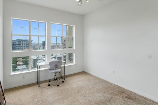 Office area featuring carpet floors, plenty of natural light, and a city view | Image 12