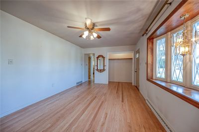 Professionally finished hardwood in living room and throughout the hallway and bedrooms. Beautiful bay windows brings in plenty of natural light. | Image 2