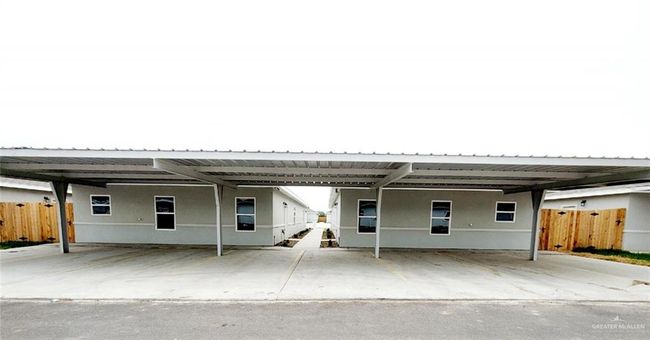 Rear view of property featuring covered parking | Image 18