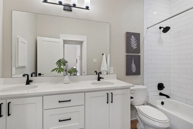 Full bath featuring toilet, double vanity, and shower / tub combination | Image 17