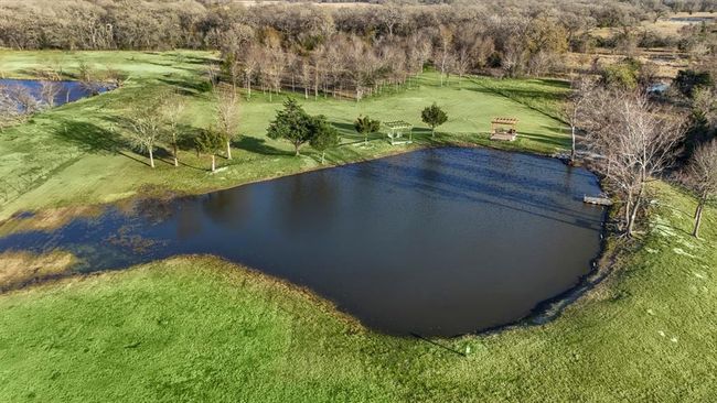 A peaceful pond anchors the outdoor spaces—inviting you to relax, explore, and enjoy the natural beauty of the property. | Image 36
