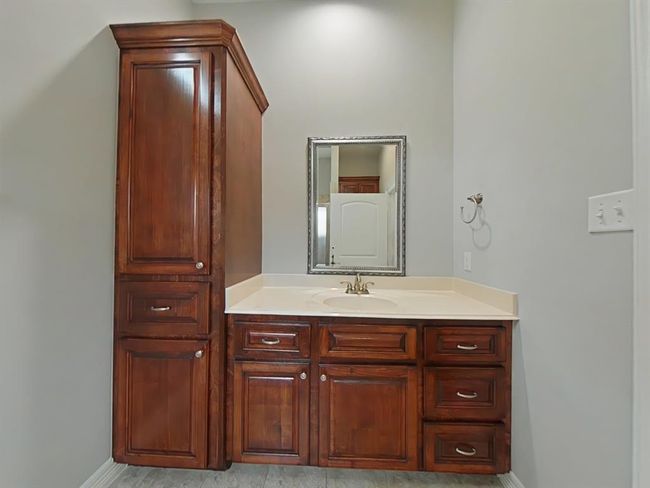 Linen closet and sink in the upstairs ensuite primary bedroom. | Image 31