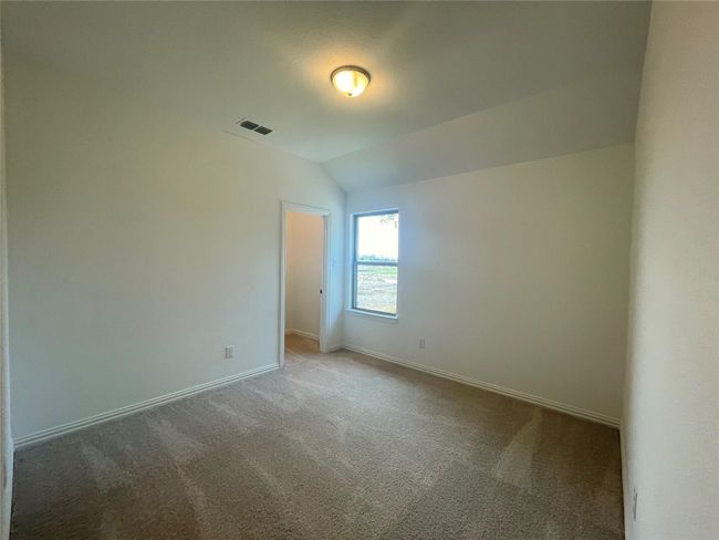 Carpeted spare room with baseboards and vaulted ceiling | Image 31