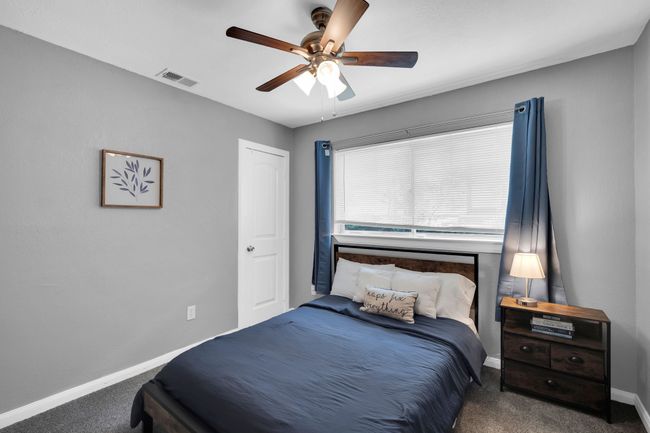 Bedroom with carpet flooring, a ceiling fan, baseboards, and visible vents | Image 22