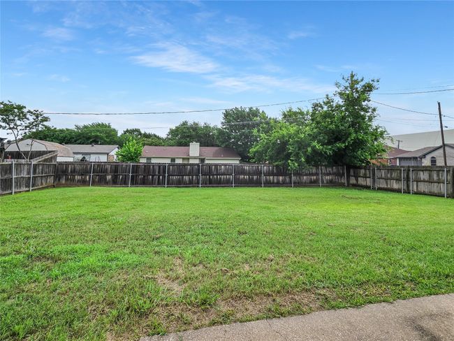 View of fenced backyard | Image 18