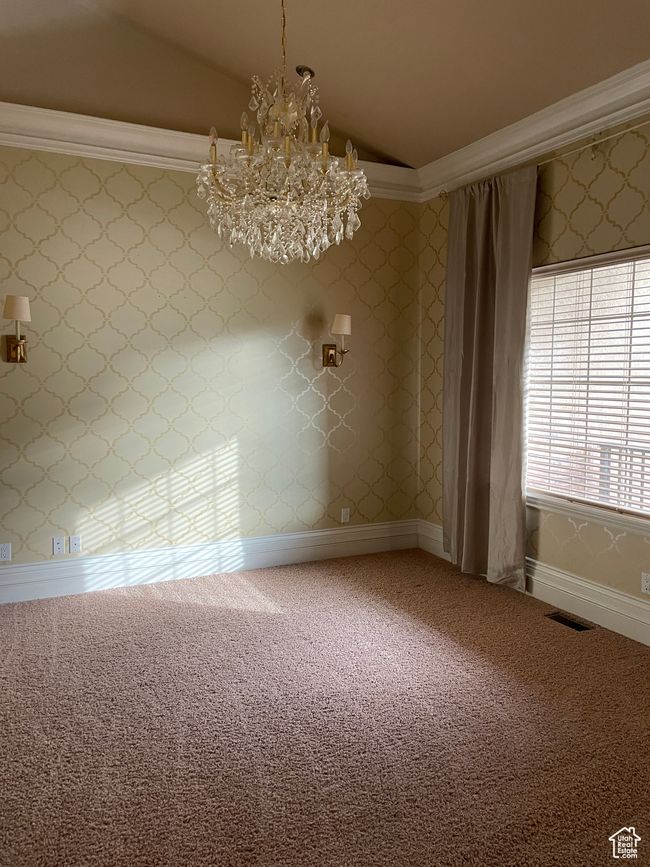 Spare room featuring lofted ceiling, a chandelier, and carpet floors | Image 10
