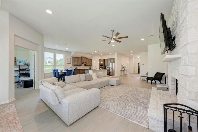 Entertaining becomes a joy, where the trio of rooms - Great Room, dining area, kitchen - flow together. The eat-on island kitchen serves double duty for both beverages and food, while encouraging lively conversation and activity. | Image 9