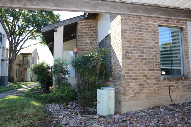 View of property exterior featuring brick siding and a central air condition unit | Image 7