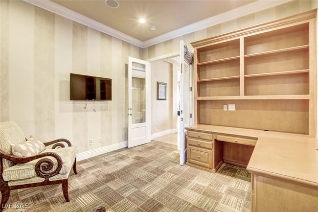 Unfurnished office featuring built in desk, baseboards, recessed lighting, ornamental molding, and french doors | Image 22