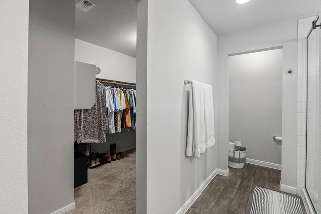 Full bathroom with a shower, wood finished floors, and a walk in closet | Image 16