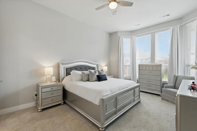 Bedroom featuring light colored carpet and a ceiling fan | Image 12