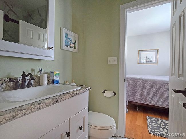 Ensuite bathroom with toilet, wood finished floors, vanity, and ensuite bathroom | Image 34