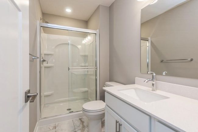 (Photo is of an inventory home, actual homes finishes will vary) This en-suite 3/4 bathroom bath provides extra privacy. | Image 21