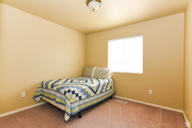 Carpeted bedroom with baseboards and visible vents | Image 24
