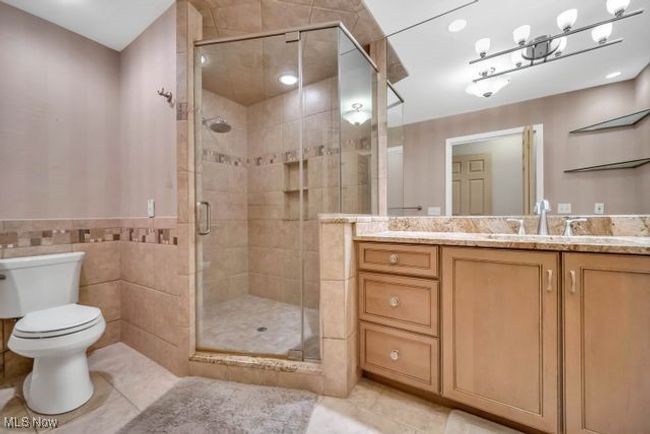 Beautifully updated bathroom off primary bedroom with beautiful cabinetry, fixtures, lighting and flooring | Image 24