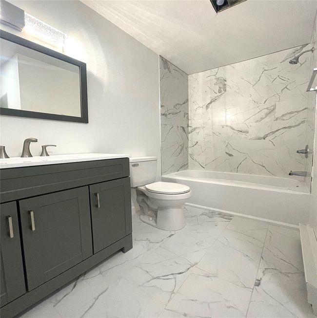 Full bathroom with toilet, shower / bathtub combination, vanity, and marble finish floor | Image 15