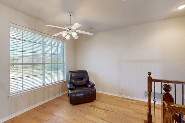 Living area with baseboards, a ceiling fan, visible vents, and light wood finished floors | Image 21