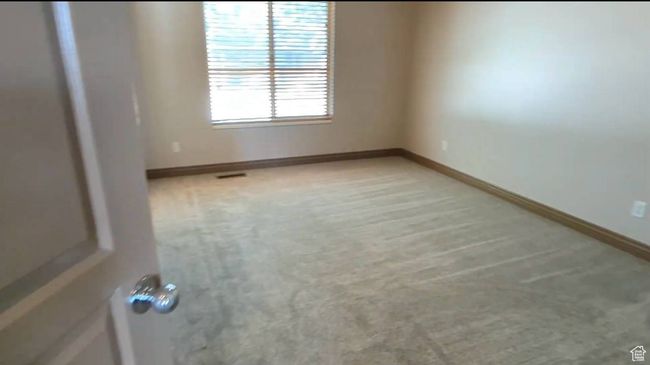 Unfurnished room with light colored carpet and baseboards | Image 68