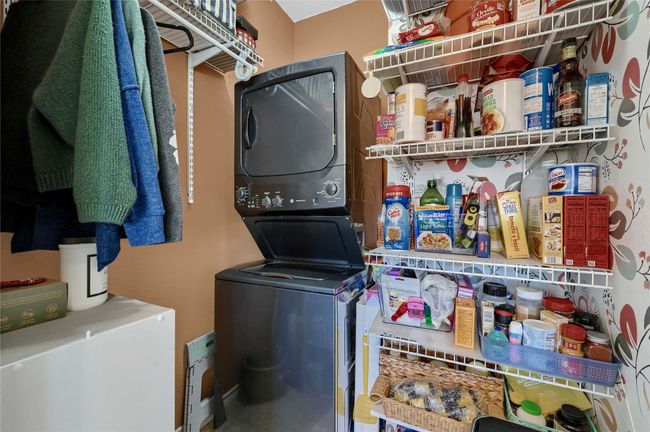 Laundry area featuring estacked washer and dryer | Image 11