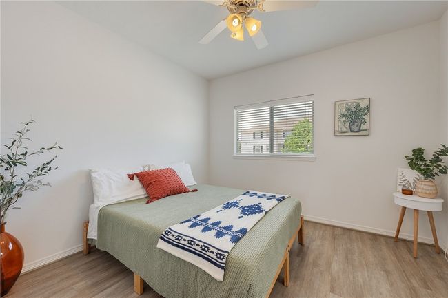Bedroom with wood finished floors and a ceiling fan | Image 11