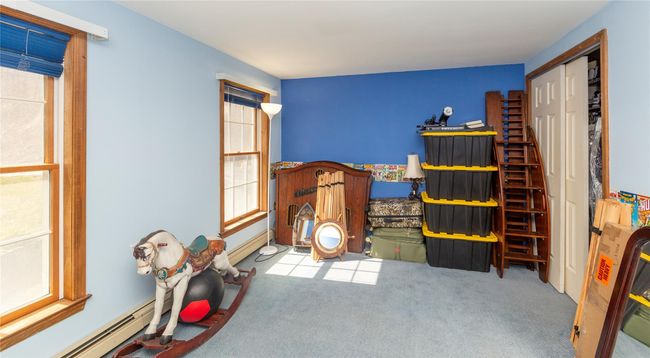 Bedroom featuring carpet flooring, a baseboard radiator, and a healthy amount of sunlight | Image 36