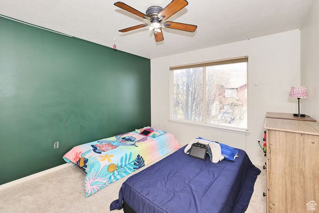Carpeted bedroom featuring ceiling fan and baseboards | Image 28