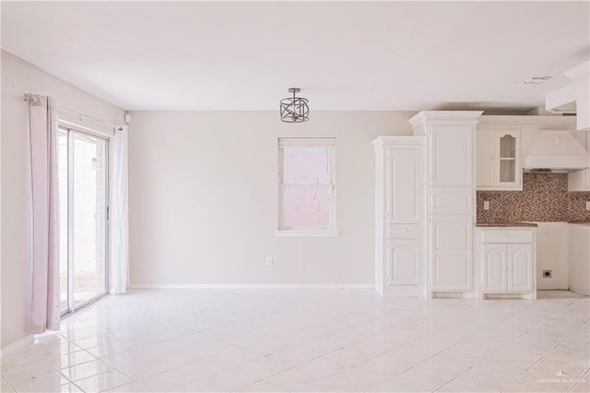 Unfurnished living room with light tile patterned floors, visible vents, and baseboards | Image 14