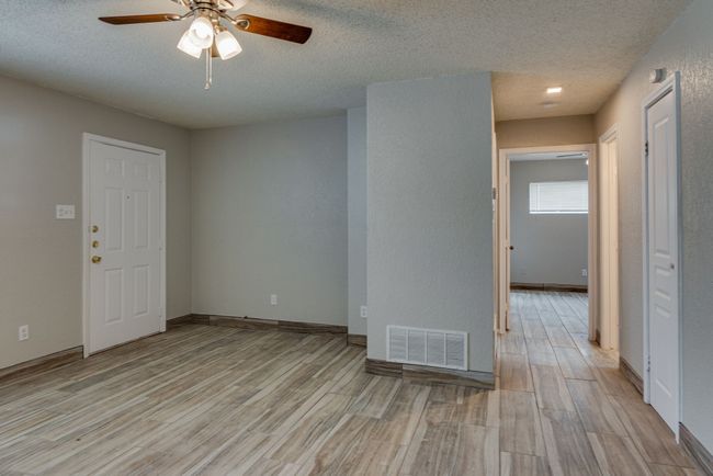Unfurnished room featuring visible vents, ceiling fan, light wood-style floors, and a textured ceiling | Image 6