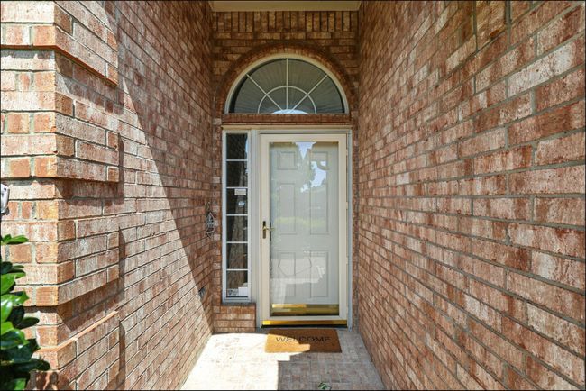Doorway to property featuring brick siding | Image 4