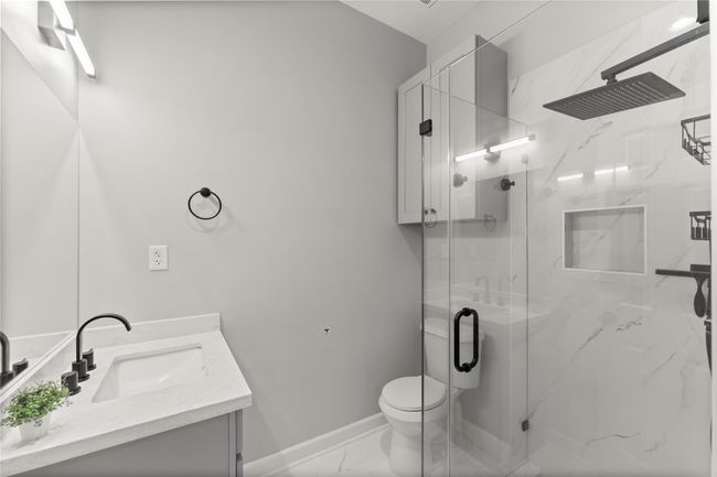 The full bathroom has clean lines, contemporary fixtures, and tasteful finishes | Image 40