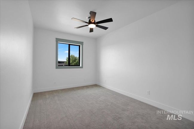 Carpeted empty room with a ceiling fan and baseboards | Image 35