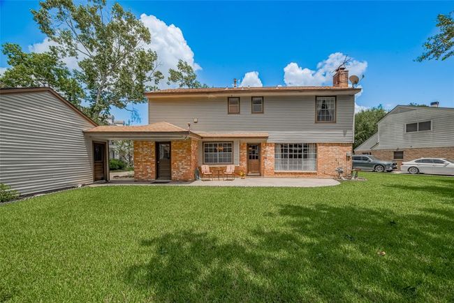 Expansive backyard with lush lawn and a welcoming patio, perfect for outdoor relaxation and entertainment. | Image 34