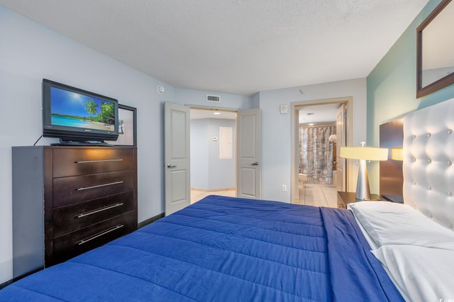 Bedroom featuring visible vents and ensuite bath | Image 15