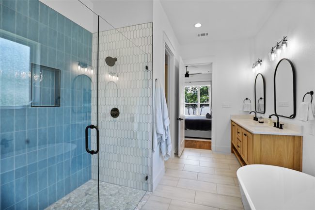 Full bathroom with a tile shower, visible vents, a sink, ceiling fan, and ensuite bathroom | Image 19