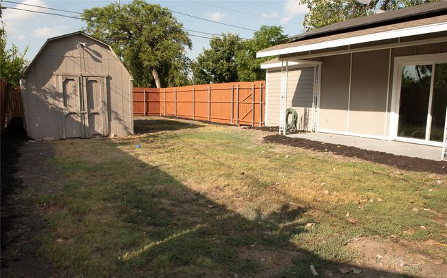 View of yard with a storage shed | Image 16